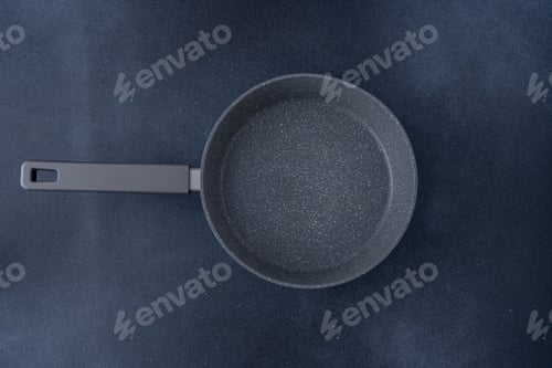 Preview: New granite frying pan on a gray background, top view. Empty fry pan with handle.