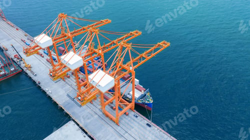 Preview: cargo container ship under big crane loading box container at Shipyard industry shipping