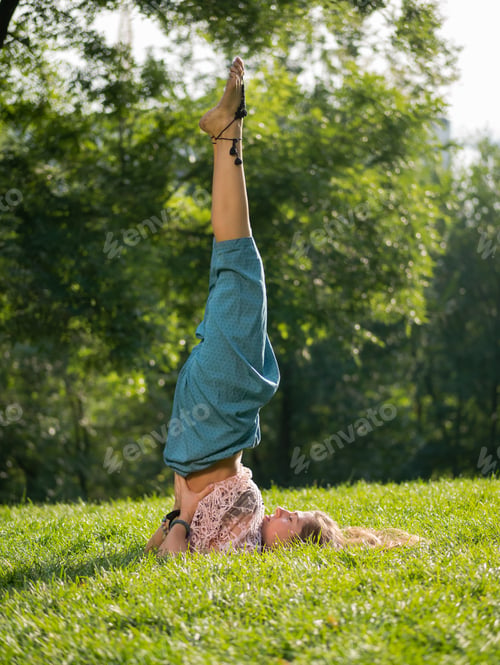 Preview: Beautiful young woman practicing yoga in the morning
