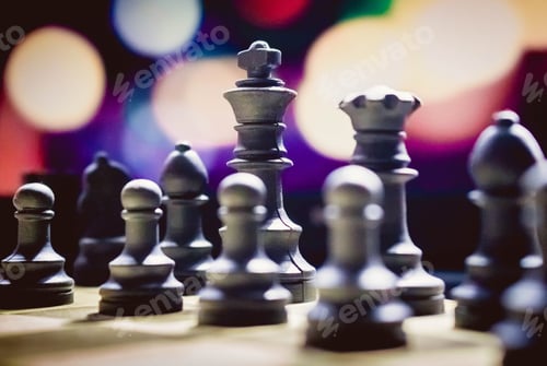 Preview: Closeup of the chess pieces on the desk with colorful bokeh lights in the blurred background