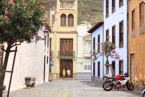 Preview: a modern married couple of lovers strolling in the old town of the island of Tenerife, a couple of