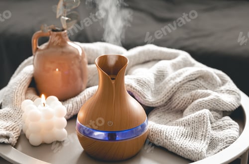 Preview: Spa composition with aroma oil diffuser lamp and candle on a blurred background.