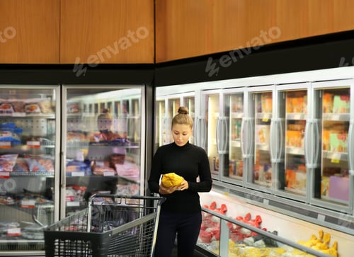 Preview: Woman Choosing Frozen Food From A Supermarket Freezer