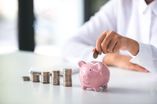 Preview: business woman holding a coin in a piggy bank On a table with sunlight. Money Saving Ideas for Finan