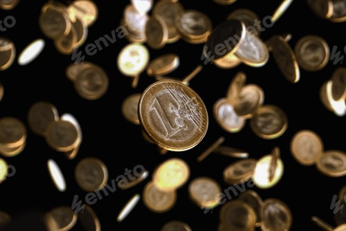 Preview: Many euro coins falling on an isolated black background