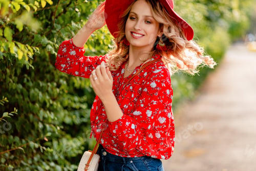 Preview: attractive stylish blond smiling woman in straw red hat and blouse summer fashion
