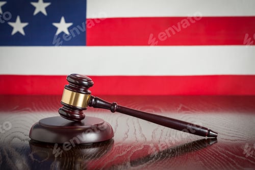 Preview: Wooden Gavel Resting on American Flag Reflecting Table.