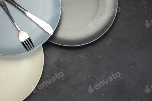 Preview: top view colored plates on dark background table glass meal kitchen food ceramic color cutlery