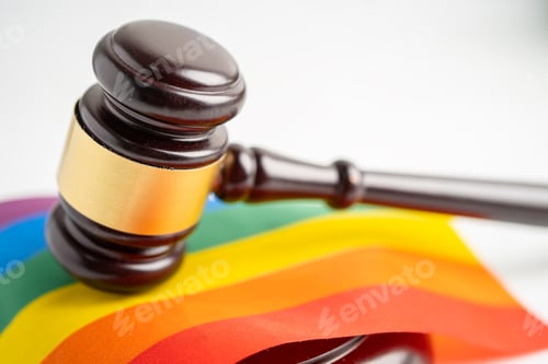 Preview: Gavel for judge lawyer on rainbow flag, symbol of LGBT pride month