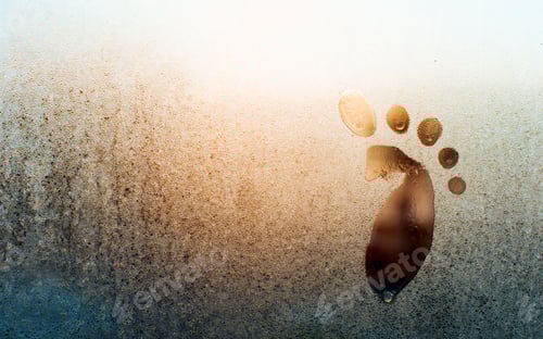 Preview: Drawing of child's foot on frozen window, copy space. Frosty pattern on glass. Funny creative