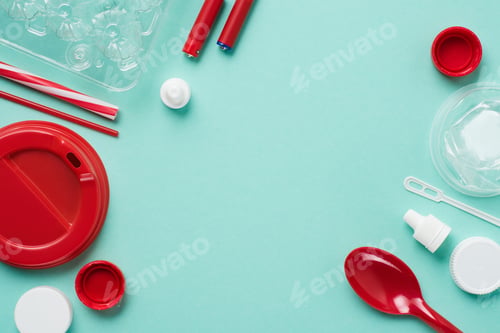 Preview: Top view of various kinds of disposable plastic waste on blue background