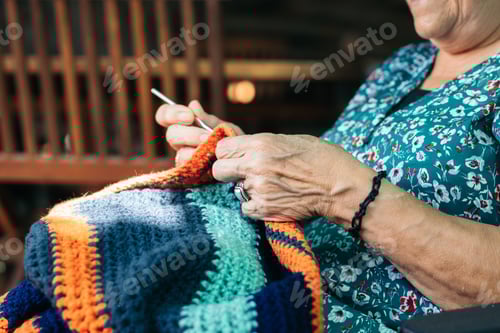 Preview: Senior Woman Knitting Colorful Yarn Inside Home
