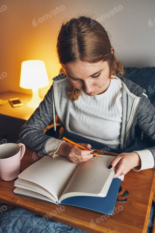 Preview: Student learning at home. Woman making notes, reading and learning from notepad, writing journal