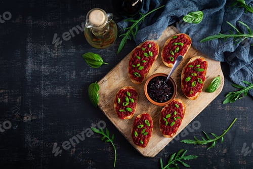 Preview: Bruschetta with grated beetroot, herbs and caramelized onion. Top view