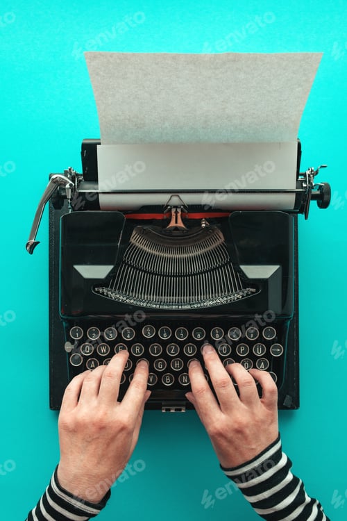 Preview: Woman typing vintage typewriter, top view