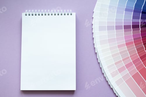 Preview: Paint samples, multicolors swatch for design. Lilac background, white paper notebook. Copy space