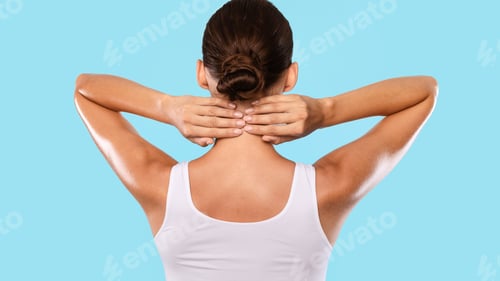 Preview: Back view of unrecognizable woman touching and massaging her neck