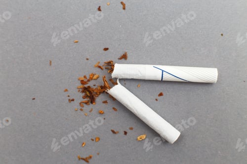 Preview: broken cigarette on gray background close. stop smoking concept