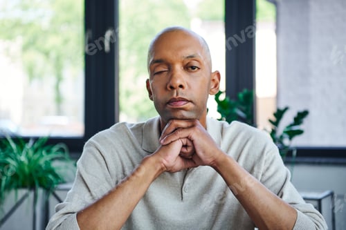 Preview: ptosis, eye syndrome, bold african american businessman looking at camera, dark skinned office