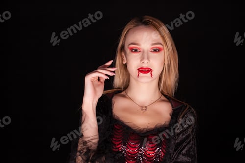 Preview: Seductive blond woman dressed up like a vampire