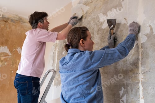 Preview: Two Adults Remove Old Wallpaper Together