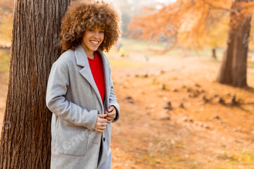 Preview: Enjoying a sunny autumn afternoon in a cozy sweater while embracing nature's vibrant hues