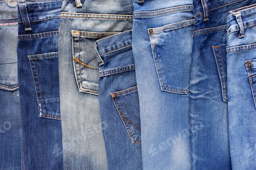 Preview: Heap of torn jeans denim background texture. Blue jeans fabric material surface