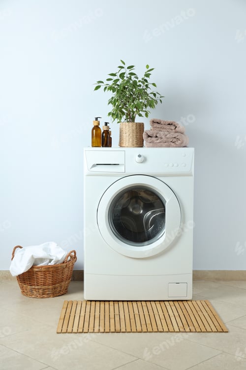 Preview: Concept of housework with washing machine against white wall