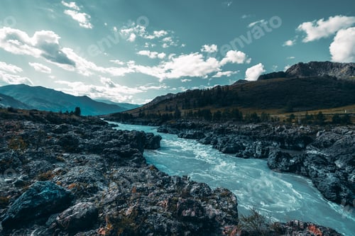 Preview: River in the mountain settings surrounded by hills and stones