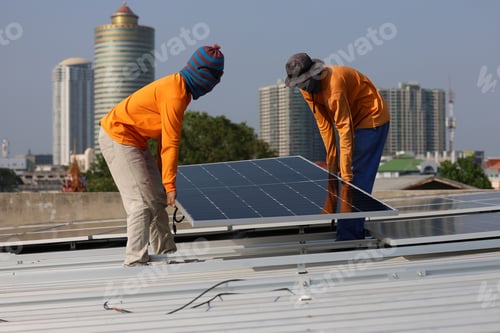 Preview: Technicians Install photovoltaic solar modules on roof of house.