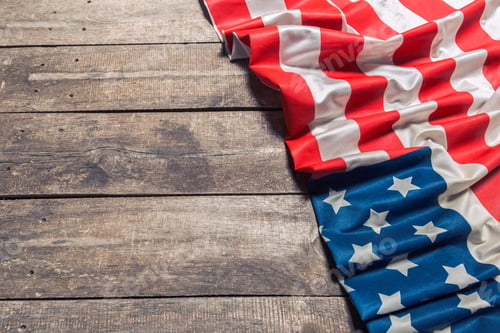 Preview: An American Flag Lying on an aged, weathered rustic wooden background