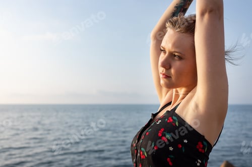 Preview: Beautiful serene young woman portrait at seaside