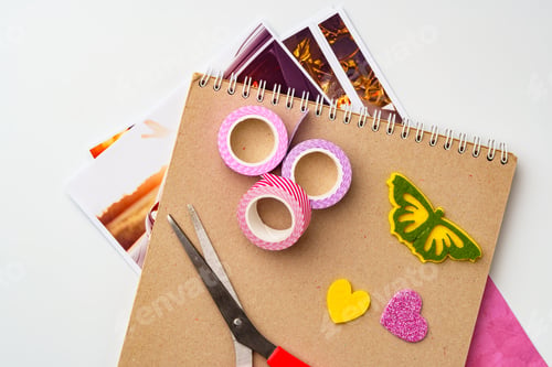 Preview: Craft supplies arranged on a table with colorful tape, scissors, and decorative paper cutouts ready