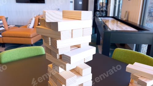 Preview: Towering Game of Wooden Blocks Teetering on the Brink