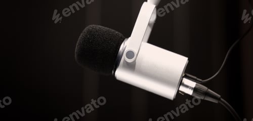 Preview: Microphone in studio. Professional studio microphone with a pop filter is suspended boom arm and studio lights. Set up mic for podcast voice over or recording high quality sound audio in a controlled.