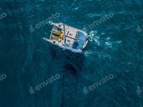 Preview: aerial top view from above of large sailing catamaran in the open sea isolated