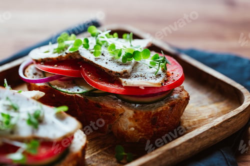 Preview: Sandwiches with turkey meat and fresh vegetables served with microgreens