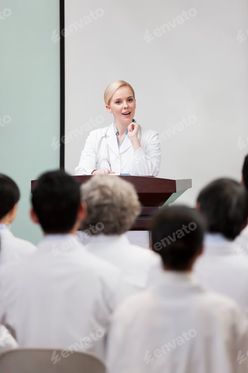 Preview: Female doctor giving speech in boardroom