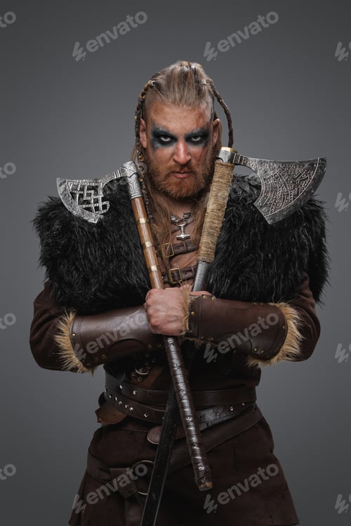 Preview: Barbaric viking with paired axes against grey background