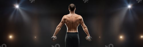 Preview: Muscular man lifting dumbbells wide banner with copy space