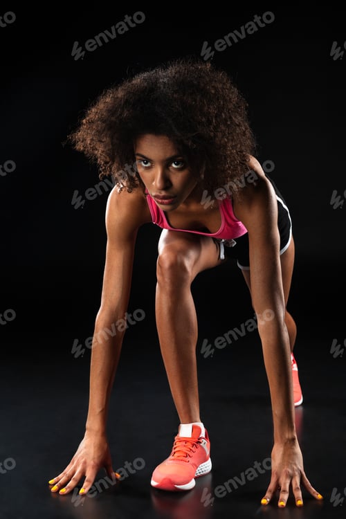 Preview: Image of athletic african american sportswoman doing exercise