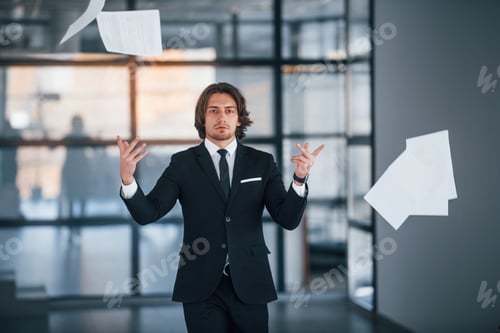 Preview: Portrait of handsome young businessman in black suit and tie