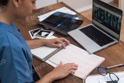 Preview: Cardiologist ECG Analysis: examines patient cardiogram ECG test results at table with a computer