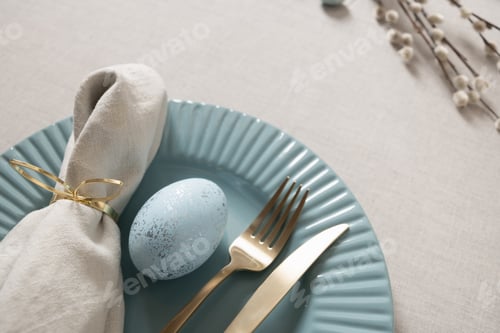 Preview: Easter table setting with blue egg and gold cutlery