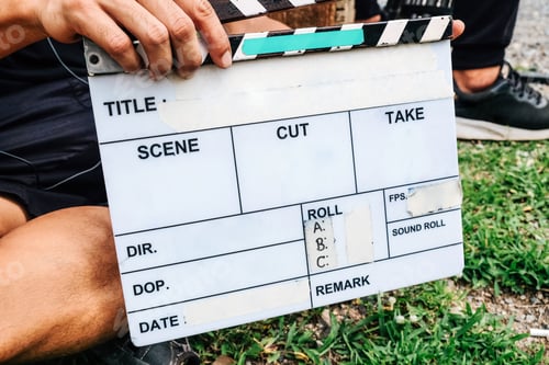 Preview: close up image of film production crew holding Film Slate on set