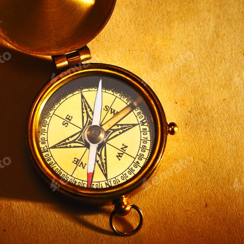 Preview: Antique brass compass over old background