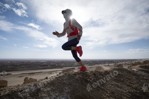 Preview: Woman trail runner cross country running on sand desert dunes
