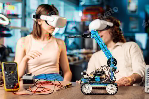 Preview: Young man and woman in VR glasses doing experiments in robotics in a laboratory