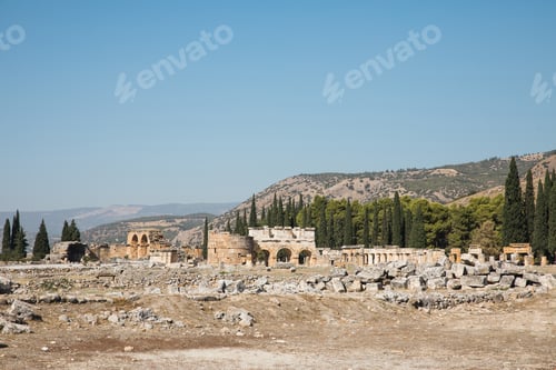 Preview: beautiful ancient architecture and mountains behind in pamukkale, turkey