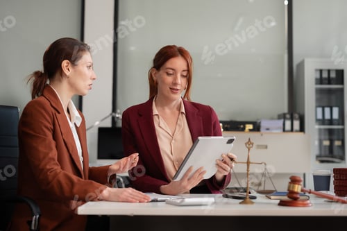 Preview: Lawyer businesswoman and two business partners working together in office.